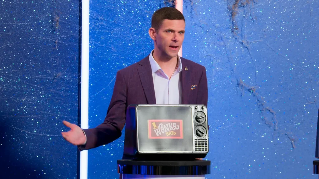 Is It Cake? Halloween Season 1 Review 1 Is It Cake Halloween Season 1 Review featuring host Mikey Day in front of a Wonka TV creation on Pop the Channel.