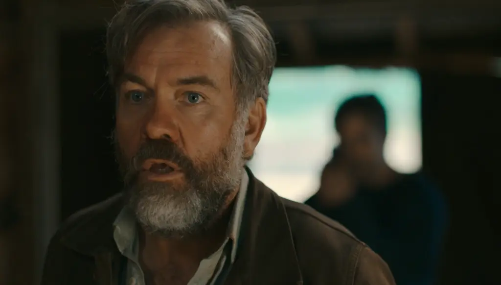 Last Seen Season 1 Episode 6: "The Choice" Review featuring Henry in the barn at the compound trying to get to Sarah with Ian holding a gun on him in the background on Pop the Channel
